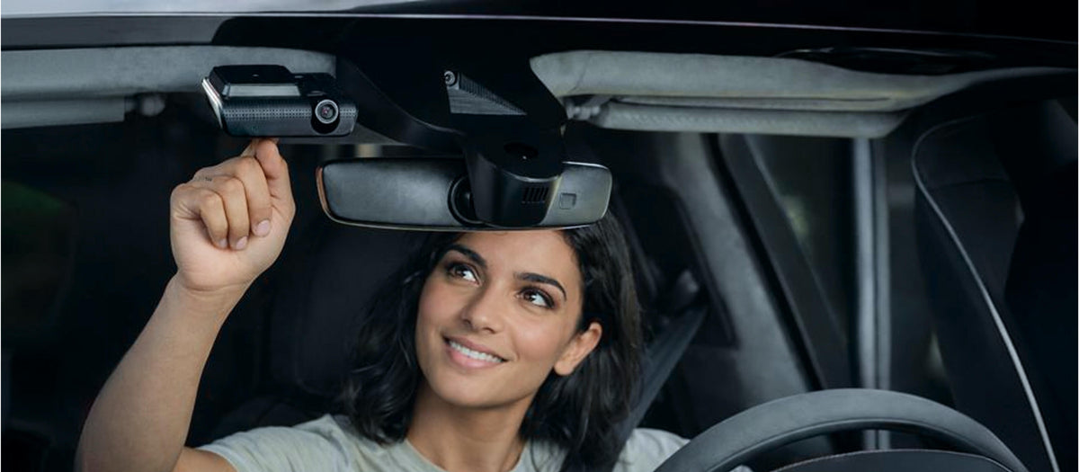 Woman touching the dash cam button